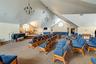 Recreation room with vaulted ceiling, plenty of natural light, a notable chandelier, and carpet
