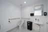 Half bath featuring light tile patterned floors, recessed lighting, and tile walls
