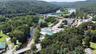 Bird's eye view of a heavily wooded area and a large body of water