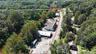 Aerial overview of property's location with property parcel outlined and a heavily wooded area