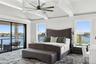 Bedroom featuring access to outside, a water view, and ceiling fan