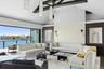 Carpeted living area with high vaulted ceiling, a water view, and recessed lighting