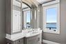 Bathroom with a water view, vanity, and baseboards