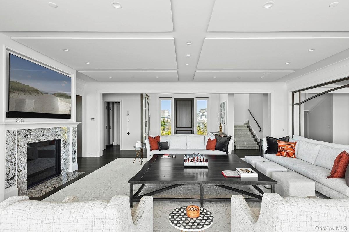Living area featuring stairway and a fireplace