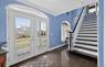 Entryway with hardwood / wood-style floors, crown molding, and french doors