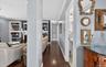 Hallway featuring dark wood finished floors, crown molding, and built in features