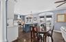 Dining area with french doors, ornamental molding, dark wood-style flooring, recessed lighting, and a ceiling fan