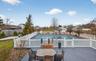 View of pool featuring a residential view, outdoor dining space, and a wooden deck