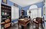 Office space with dark wood-style flooring and ornamental molding