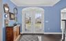 Doorway featuring ornamental molding, wood finished floors, and french doors