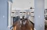 Dining space featuring decorative columns, dark wood finished floors, ornamental molding, recessed lighting, and a ceiling fan