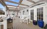 Wooden terrace featuring outdoor dining area and french doors