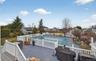 View of pool with a fenced backyard, a residential view, a deck, and grilling area