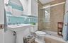 Full bathroom with a stall shower and light tile patterned floors