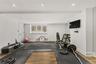 Elevate your daily routine in this versatile, light-filled space, perfectly suited for a high-end home gym or wellness studio. With sleek finishes and