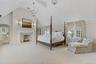Luxurious primary suite featuring generous proportions, abundant natural light, and a serene, private ambiance.