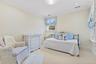 Carpeted bedroom featuring crown molding and recessed lighting.