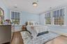 Bedroom featuring dark wood-type flooring, ornamental molding, and recessed lighting.