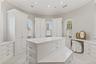 Spacious walk-in closet with custom built-ins offering exceptional storage and organization.
