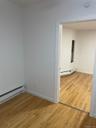 Spare room featuring light wood-style floors and baseboard heating