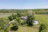View of property location featuring a heavily wooded area and rural landscape