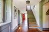 Stairs with hardwood / wood-style floors and baseboards