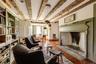 Living room with hardwood / wood-style floors and beamed ceiling