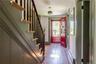 Foyer with wood-type flooring, stairs, and baseboards