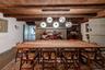 Dining space featuring wooden ceiling with exposed beams