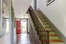 Stairway featuring hardwood / wood-style flooring, a chandelier, and baseboards