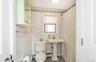 Bathroom with tile patterned flooring, toilet, tile walls, and a baseboard heating unit