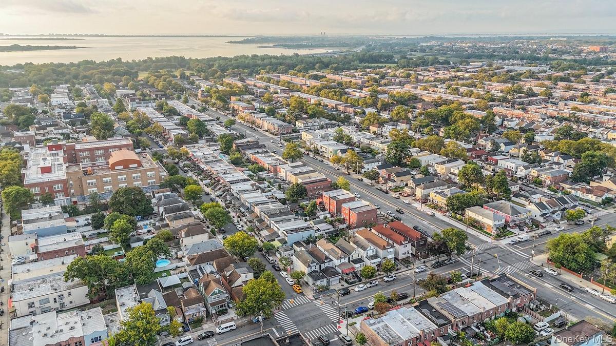 Aerial view of property and surrounding area featuring a nearby body of water