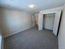 Unfurnished bedroom featuring carpet flooring and a large closet