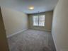Unfurnished room featuring gray colored carpet