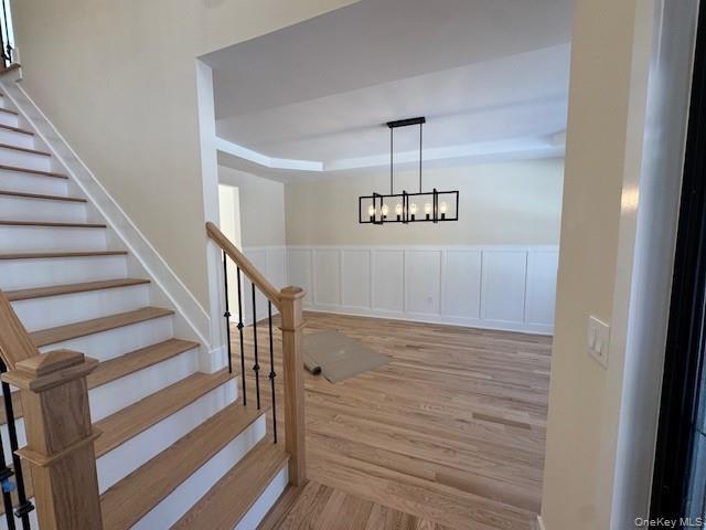 Foyer opens up to dining area with wood floors