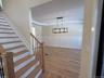 Foyer opens up to dining area with wood floors