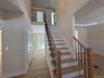Stairway with a high ceiling and wood finished floors