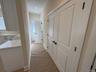 Washer/Dryer in first set of doors, Half Bath at end of hallway