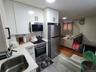 Kitchen featuring light countertops, white cabinets, and appliances with stainless steel finishes