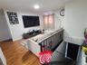 Living area featuring wood finished floors and baseboards