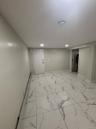 Finished basement with baseboards and marble finish floor