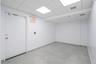 Finished basement with baseboards and a drop ceiling