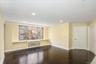 Empty room with dark wood-style flooring and recessed lighting