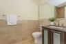 Full bathroom with tile walls, vanity, and light tile patterned floors