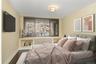 Bedroom featuring baseboards and wood finished floors