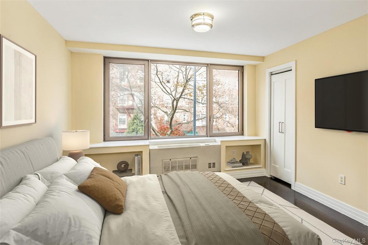 Bedroom featuring baseboards and dark wood-type flooring