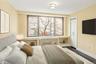 Bedroom featuring baseboards and dark wood-type flooring