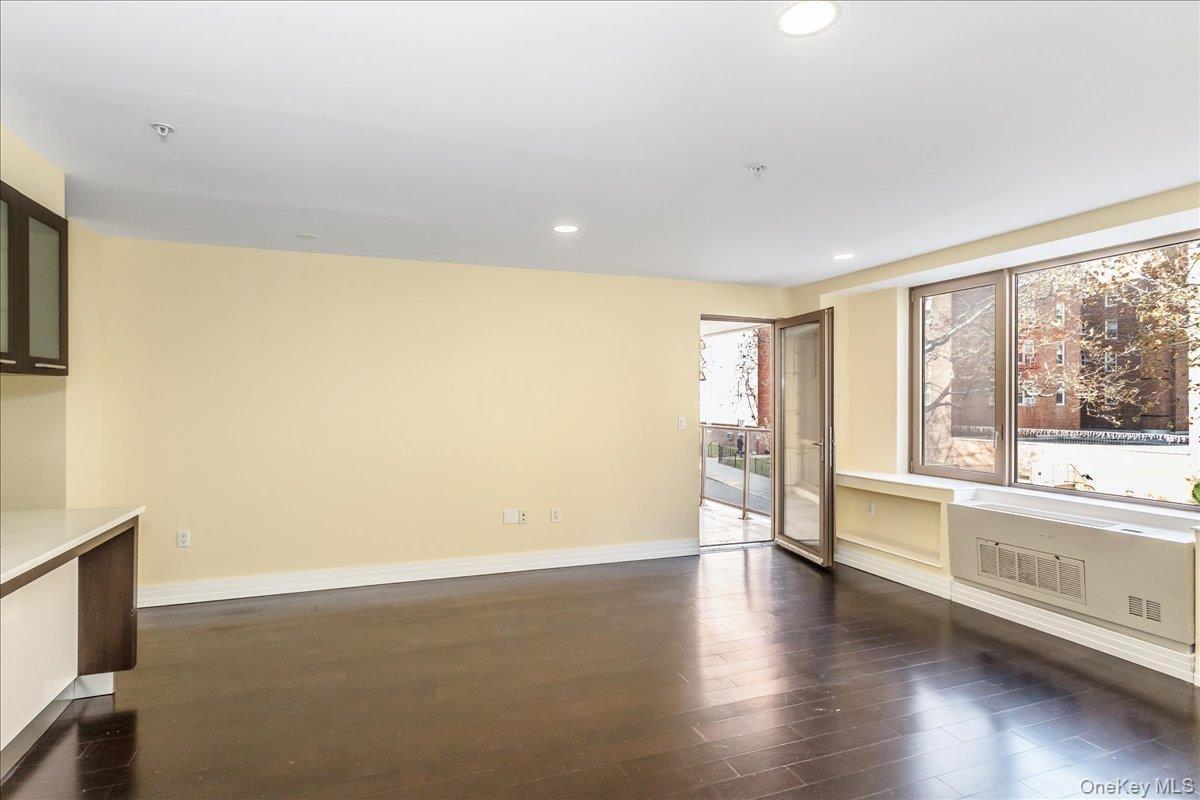 Unfurnished room with recessed lighting and dark wood-style flooring