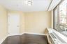 Empty room featuring baseboards and dark wood-style flooring