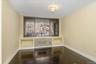 Unfurnished dining area with dark wood-type flooring and baseboards